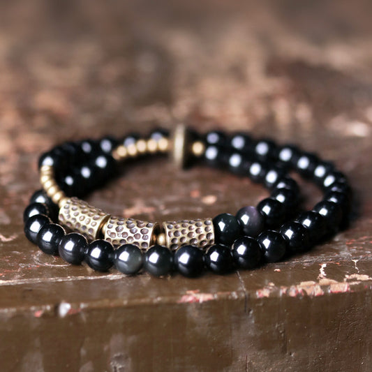 Side view showing the layered structure and the rhythmic placement of lattice brass spheres.