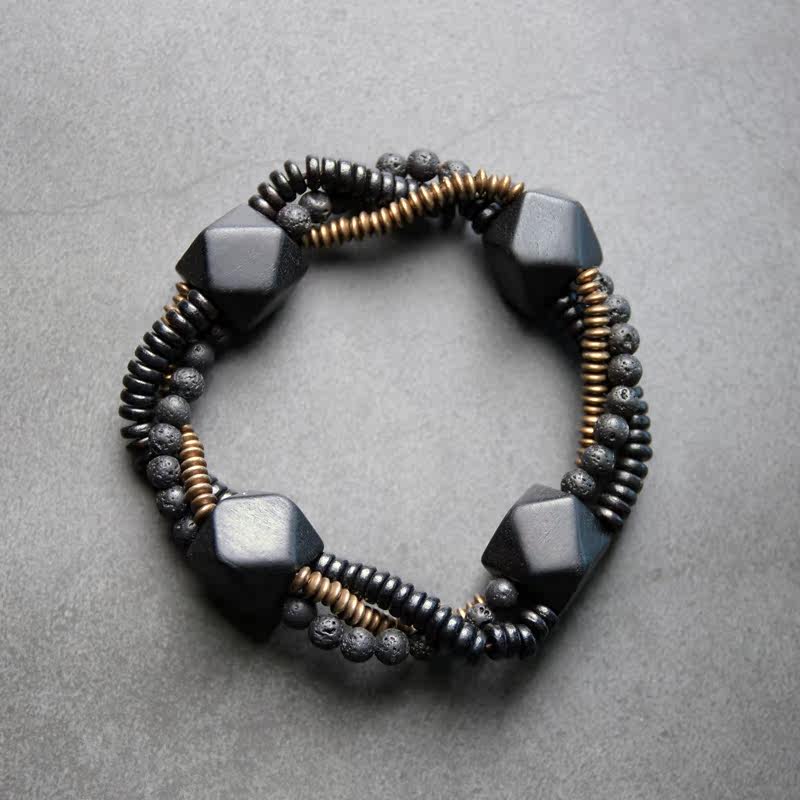 Macro detail of porous black Lava Rock beads on a Serene Lucky bracelet, perfect for essential oil diffusion and aromatherapy.