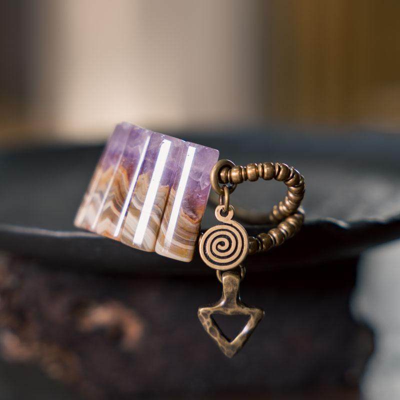 Close-up detail of Serene Lucky amethyst slab bracelet, showing the natural violet crystalline structure and the matte finish of the brass link hardware.