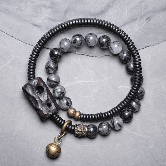 Serene Lucky multi-layer bracelet with natural Black Rutilated Quartz, dark Ebony Wood beads, and architectural antiqued brass accents.