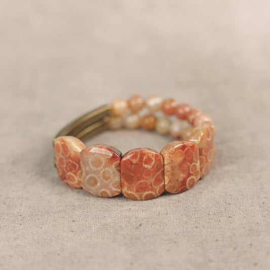 A handcrafted Serene Lucky statement bracelet featuring rectangular Fossil Coral slabs and textured antiqued brass beads in an architectural hand-slab design.